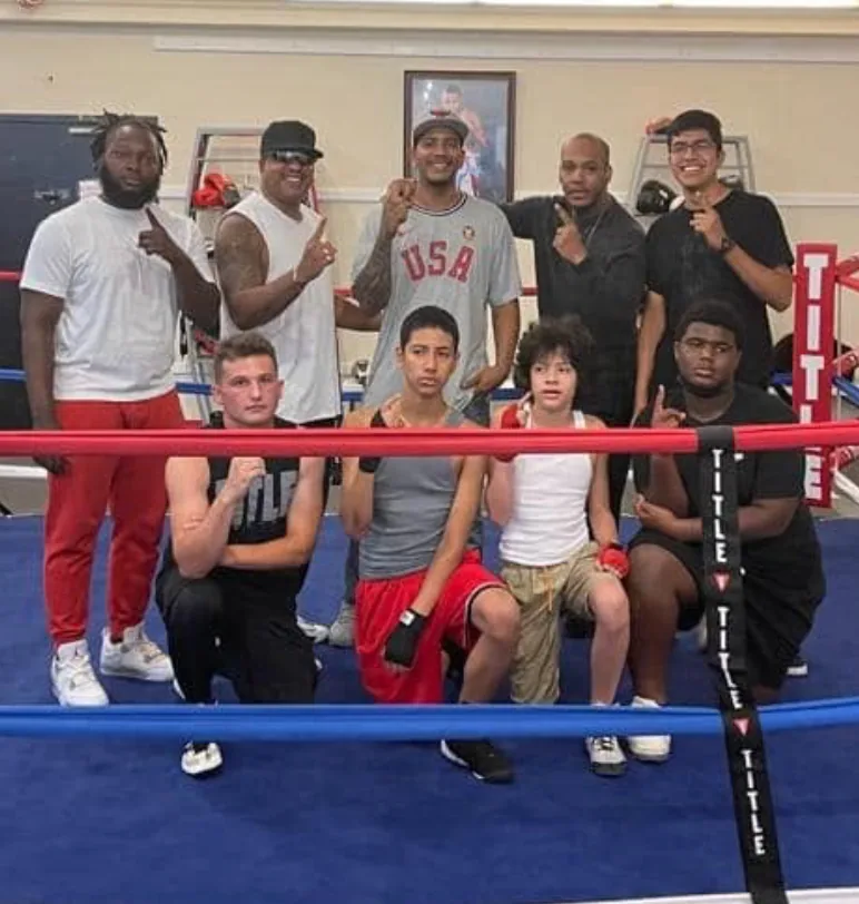 Romero's Boxing School team celebrating together in the ring